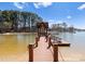 Scenic view of a private wooden dock with gazebo, offering direct access to the serene waterfront and boating opportunities at 17925 Kings Point Dr # J, Cornelius, NC 28031