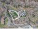 Aerial shot showcasing the house, driveway, lush lawn, landscaping, and surrounding wooded areas at 1816 Country Garden Dr, Shelby, NC 28150
