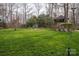 Expansive backyard featuring lush green lawn, mature trees and landscaping, great for outdoor enjoyment at 1816 Country Garden Dr, Shelby, NC 28150