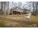 Extensive backyard with multiple structures, including a deck and outdoor seating at 1816 Country Garden Dr, Shelby, NC 28150