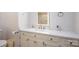 Bathroom featuring a white vanity with marble countertop, bronze hardware, lighted mirror, and ample storage space at 1816 Country Garden Dr, Shelby, NC 28150
