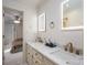 Bright bathroom with dual sinks, marble countertop, bronze fixtures and lighted mirrors; bedroom viewable through doorway at 1816 Country Garden Dr, Shelby, NC 28150