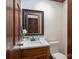 Charming bathroom features a framed mirror, white marble countertop, wood vanity, sink, and toilet at 1816 Country Garden Dr, Shelby, NC 28150