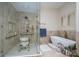 Modern bathroom with a walk-in shower featuring grab bars and seating, plus a luxurious soaking tub under shuttered windows at 1816 Country Garden Dr, Shelby, NC 28150
