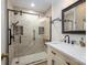 Bathroom featuring a stylish glass-enclosed shower with bronze hardware, tiled walls, and a marble-topped vanity at 1816 Country Garden Dr, Shelby, NC 28150
