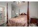 Bedroom featuring a four-poster bed, neutral walls with white trim, and access to the ensuite bathroom at 1816 Country Garden Dr, Shelby, NC 28150