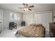 Well-lit bedroom features neutral walls, white trim, a ceiling fan, shuttered windows, and a comfortable bed with matching chairs at 1816 Country Garden Dr, Shelby, NC 28150