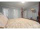 Bedroom with neutral paint and bedding, features a four-poster bed and two doors to the bathroom and closet at 1816 Country Garden Dr, Shelby, NC 28150
