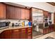 Spacious kitchen with stainless steel appliances, including a refrigerator and oven, complemented by granite countertops and wood cabinets at 1816 Country Garden Dr, Shelby, NC 28150
