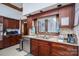 Charming kitchen features wood cabinets, granite countertops, stainless steel appliances, and a double bowl stainless sink at 1816 Country Garden Dr, Shelby, NC 28150