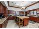 Spacious kitchen with a large island, tile floors, and wood cabinets at 1816 Country Garden Dr, Shelby, NC 28150