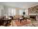 Cozy living room with a brick fireplace, plush seating, and plantation shutters at 1816 Country Garden Dr, Shelby, NC 28150