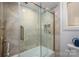 Modern bathroom with glass-enclosed shower featuring bronze hardware, tile surround, and storage niches; toilet visible at 1816 Country Garden Dr, Shelby, NC 28150
