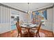 Cozy dining room with hardwood floors, elegant chandelier, and a view to the kitchen at 1911 Connemara Ct, Gastonia, NC 28054