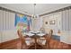 Bright dining room featuring a glass-top table, wood chairs, and a window with charming curtains at 1911 Connemara Ct, Gastonia, NC 28054
