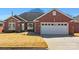 Charming brick home with a well-maintained lawn and attached two-car garage at 1911 Connemara Ct, Gastonia, NC 28054