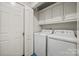 Bright laundry room with white cabinetry, washer, and dryer for convenient chore completion at 1911 Connemara Ct, Gastonia, NC 28054