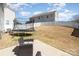 Backyard with trampoline, patio seating, and a white picket fence at 19113 Hawk Haven Ln, Charlotte, NC 28278
