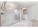 The spacious bathroom features marble tile, glass shower and a double sink vanity at 19113 Hawk Haven Ln, Charlotte, NC 28278