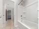 The bathroom features a tub with white tile surround and marble flooring at 19113 Hawk Haven Ln, Charlotte, NC 28278