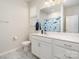 Bright bathroom featuring white vanity, marble floors, and a shower at 19113 Hawk Haven Ln, Charlotte, NC 28278
