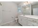 Bright bathroom with marble tile floors, a large mirror, and a single sink vanity at 19113 Hawk Haven Ln, Charlotte, NC 28278