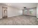 Spacious bedroom with plush carpeting, ceiling fan, and bathroom access at 19113 Hawk Haven Ln, Charlotte, NC 28278