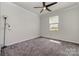 Bedroom featuring neutral walls, ceiling fan and window providing natural light at 19113 Hawk Haven Ln, Charlotte, NC 28278