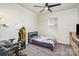Cozy bedroom featuring carpet, ceiling fan and a large window at 19113 Hawk Haven Ln, Charlotte, NC 28278