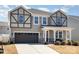 Charming two-story home with neutral siding, black trim, covered porch, and a well-maintained lawn at 19113 Hawk Haven Ln, Charlotte, NC 28278
