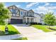 Two-story home with a two-car garage, well-manicured lawn, and a long driveway at 19113 Hawk Haven Ln, Charlotte, NC 28278