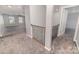 Upstairs hallway features a wrought iron railing and carpeted floors at 19113 Hawk Haven Ln, Charlotte, NC 28278