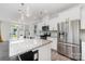 Modern kitchen boasts granite counters, stainless steel appliances, white cabinets, and a large island at 19113 Hawk Haven Ln, Charlotte, NC 28278