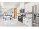 Bright kitchen with white cabinets, stainless steel appliances, granite countertops, and hardwood-style floors at 19113 Hawk Haven Ln, Charlotte, NC 28278