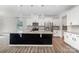 Bright kitchen with stainless steel appliances, granite countertops, island, and white cabinets at 19113 Hawk Haven Ln, Charlotte, NC 28278