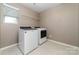 Functional laundry room with a washer, dryer, and a wire shelf for storage at 19113 Hawk Haven Ln, Charlotte, NC 28278