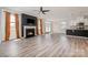 Open-concept living area with a fireplace, ceiling fan, recessed lighting, and LVP flooring at 19113 Hawk Haven Ln, Charlotte, NC 28278