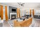 Inviting living room featuring a fireplace, stylish furniture, a modern ceiling fan, and hardwood-style floors at 19113 Hawk Haven Ln, Charlotte, NC 28278