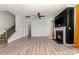 Open-concept living room with a fireplace, ceiling fan, recessed lights, and LVP flooring at 19113 Hawk Haven Ln, Charlotte, NC 28278