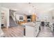 Open concept kitchen with island, dining area, and living room, hardwood style floors, and a staircase at 19113 Hawk Haven Ln, Charlotte, NC 28278