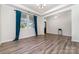 A well-lit living room with luxury vinyl plank flooring, tray ceiling, and large window at 19113 Hawk Haven Ln, Charlotte, NC 28278