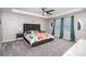 Main bedroom features a tray ceiling, ceiling fan, and a bed at 19113 Hawk Haven Ln, Charlotte, NC 28278
