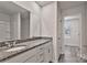 Bathroom vanity with granite countertop, white cabinets and framed mirror at 2101 Arapaho Dr, Charlotte, NC 28214