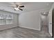 This bedroom features wood-look flooring, neutral walls, and a ceiling fan with lighting fixture at 2101 Arapaho Dr, Charlotte, NC 28214