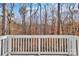 White deck overlooking a serene wooded backyard at 2101 Arapaho Dr, Charlotte, NC 28214