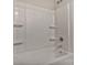 A white fiberglass shower and tub enclosure features molded shelves at 2101 Arapaho Dr, Charlotte, NC 28214