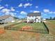 Spacious backyard showcases a well-maintained lawn enclosed by a black fence, offering privacy and room to roam at 2167 Whispering Winds Dr, Rock Hill, SC 29732