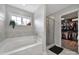Elegant bathroom with soaking tub, glass enclosed shower, and walk-in closet access at 2167 Whispering Winds Dr, Rock Hill, SC 29732