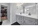 Bathroom featuring a dual sink vanity, framed mirror, and walk-in closet access at 2167 Whispering Winds Dr, Rock Hill, SC 29732