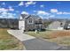 Beautiful two-story brick home featuring a welcoming front porch and long driveway on a sunny day at 2167 Whispering Winds Dr, Rock Hill, SC 29732